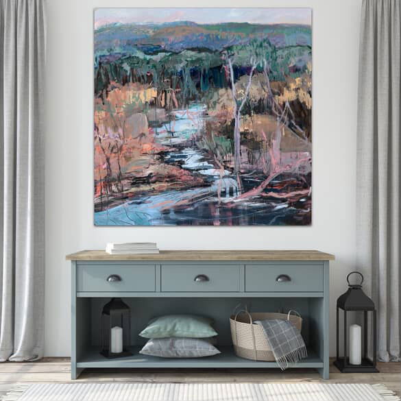 Framed abstract landscape painting above a console table with decorative items.